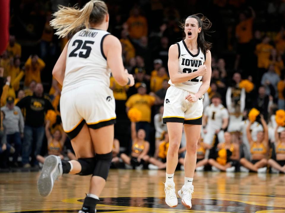 Caitlin Clark celebrates making a three-pointer.