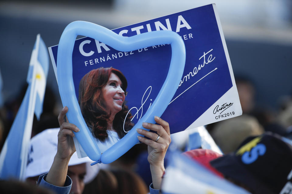 In this Oct. 17, 2019 photo, a supporter holds a heart-shaped balloon and a campaign sign promoting former Argentine President Cristina Fernandez de Kirchner, who is running as a vice presidential candidate in the upcoming general elections, during a campaign rally in Santa Rosa, Argentina. Fernandez de Kirchner retains immense popularity among Argentines who view her as a champion of the poor. Supporters wear T-shirts with her image, refer to her affectionately by her initials “CFK” and barely mention a running mate who was once Cabinet chief when she was president. (AP Photo/Natacha Pisarenko)