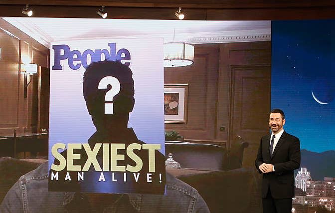 Jimmy Kimmel standing by a screen with a People magazine cover showing a question mark above "Sexiest Man Alive!"