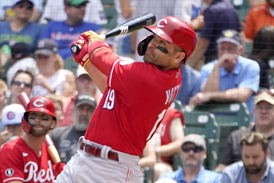 Cincinnati Reds' Joey Votto, right, andTyler Naquin watch Votto's two-run home run off Chicago Cubs starting pitcher Alec Mills during the first inning of a baseball game Thursday, July 29, 2021, in Chicago. Jesse Winker also scored on the play. (AP Photo/Charles Rex Arbogast)