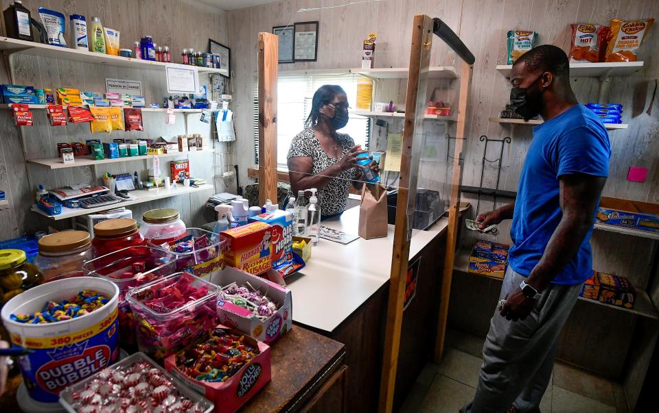 Dorothy Oliver talks with a customer at her General Store in Panola, Ala., on Aug. 18. Oliver has persuaded and helped almost everyone in her community to get their COVID-19 vaccinations.