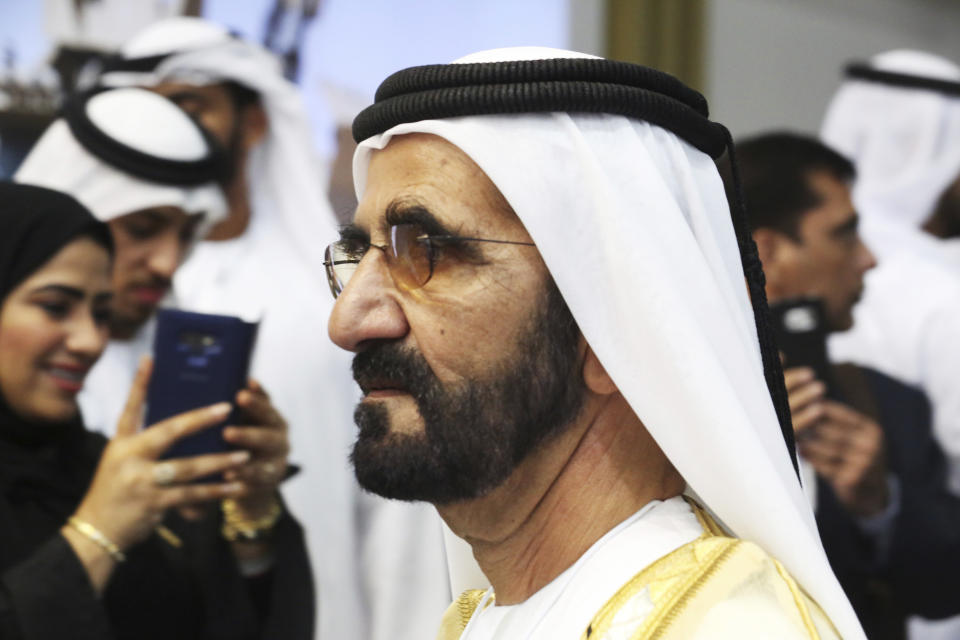 Dubai's ruler, Sheikh Mohammed bin Rashid Al Maktoum, walks through the International Defense Exhibition and Conference in Abu Dhabi, United Arab Emirates, Sunday, Feb. 17, 2019. The biennial arms show in Abu Dhabi comes as the United Arab Emirates faces increasing criticism for its role in the yearlong war in Yemen. (AP Photo/Jon Gambrell)