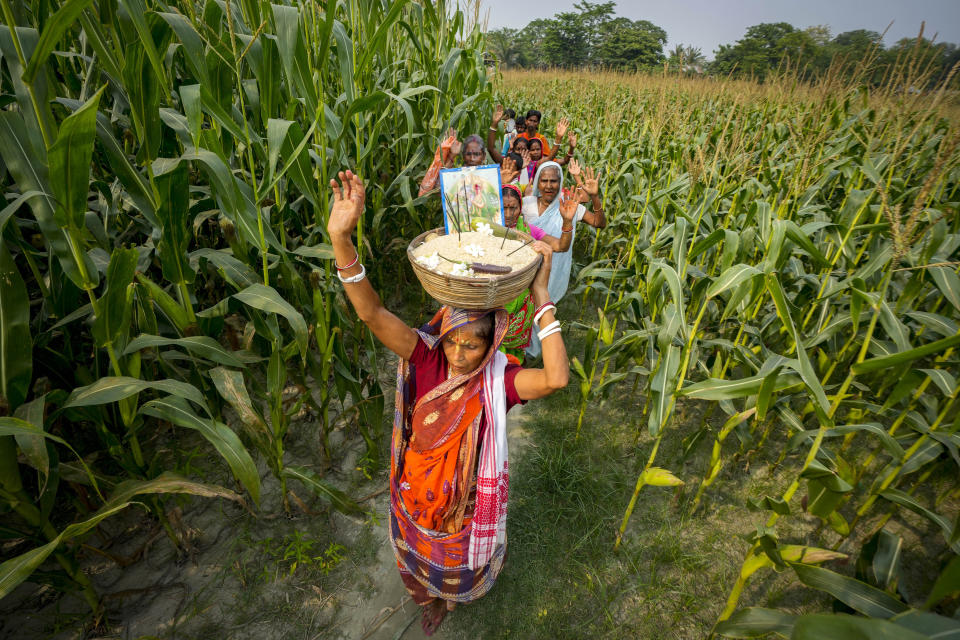 Hindu villagers celebrating Bengali New Year perform a ritual in Murkata village, north eastern Assam state, India, April 15, 2023. Nearly 2 million people, or over 5% of Assam's population, could be stripped of their citizenship unless they have documents dating back to 1971 that show their ancestors entered the country legally from neighboring Bangladesh. Many believe Assam is overrun with immigrants from Bangladesh, and hundreds have been put in detention centers unable to produce documents to prove they're Indian. (AP Photo/Anupam Nath)