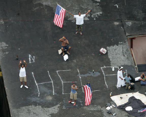 Residents wait on a rooftop to be rescued from the floodwaters of Hurricane Katrina, on Sept. 1, 2005, in New Orleans.