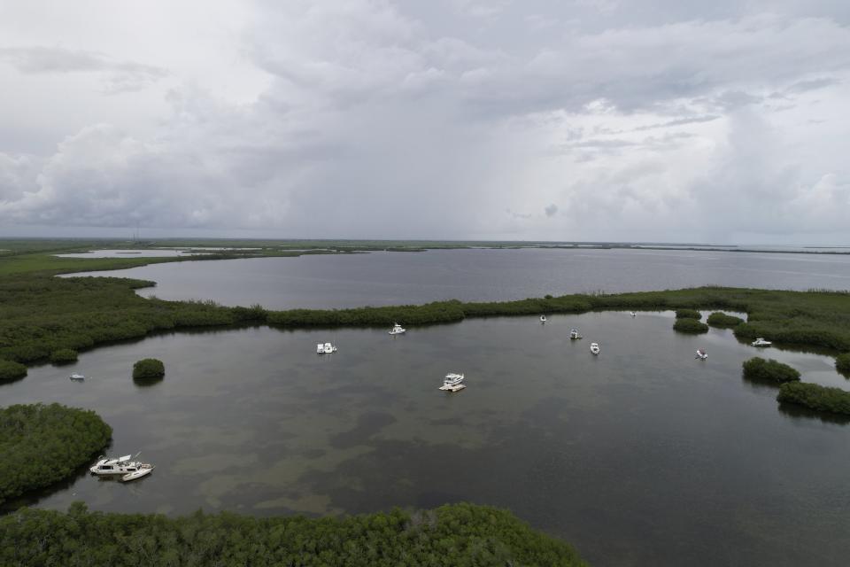 Boats are anchored at Manatee Bay off the Florida coast near Key Largo, on Friday, July 28, 2023. Triple-digit ocean temperatures are stunning even in Florida, where residents are used to the heat. (AP Photo/Daniel Kozin)
