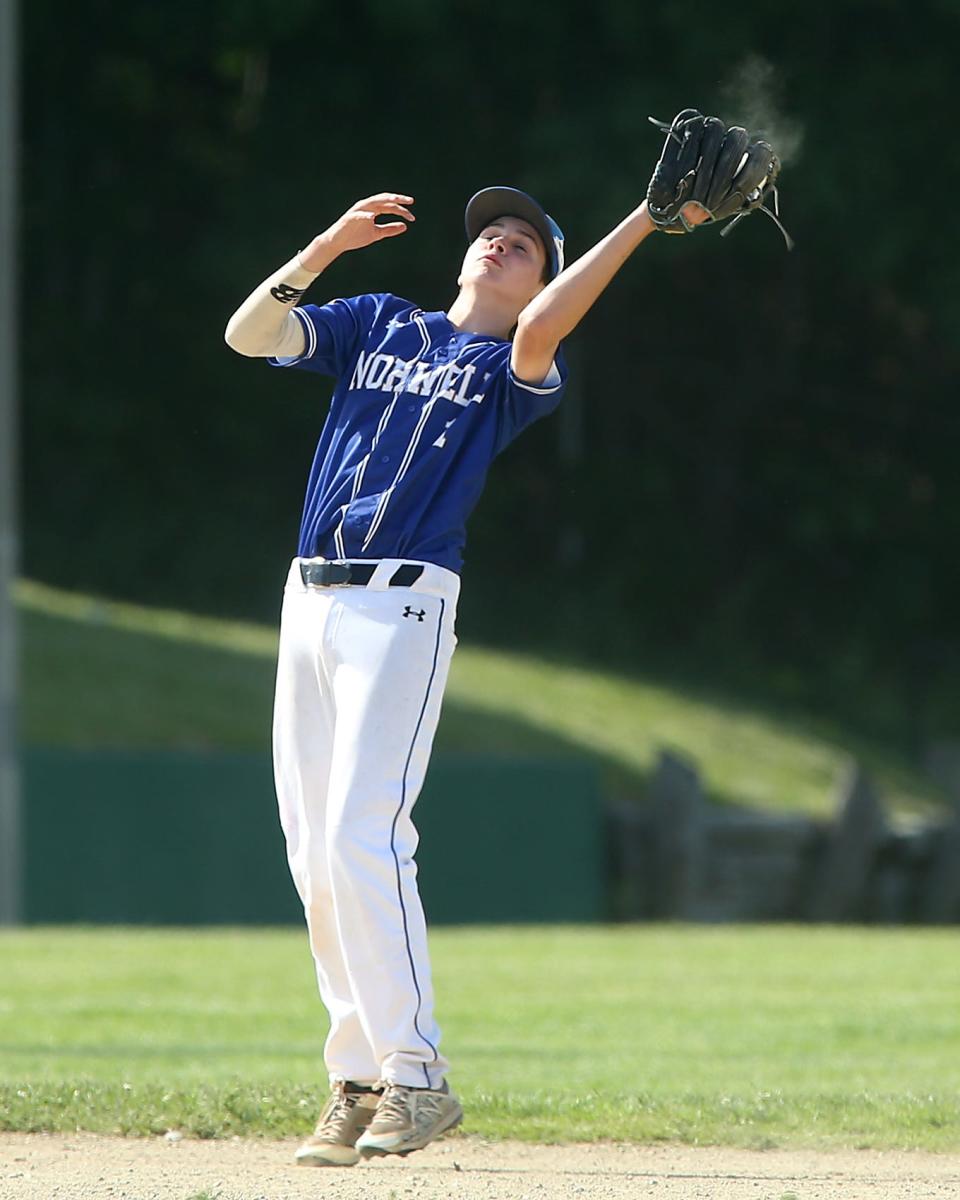 Norwell's Garrett Fisher makes the catch at shortstop in the bottom of the first inning of their game against Abington at Frolio Field in Abington on Wednesday, May 25, 2022. Abington head coach Steve Perakslis won his 300th win with the victory.
