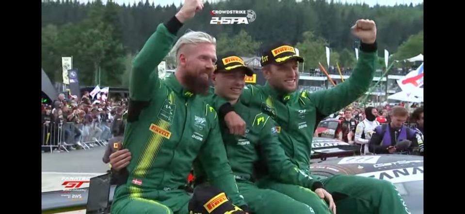 a group of men in green racing suits