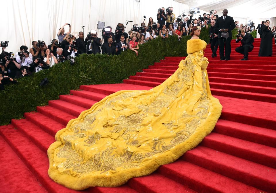 most iconic met gala looks, Rihanna yellow dress, guo pei, arrives at the 2015  Metropolitan Museum of Art's Costume Institute Gala benefit in honor of the museums latest exhibit China: Through the Looking Glass  May 4, 2015 in New York.      AFP PHOTO /  TIMOTHY  A. CLARY        (Photo credit should read TIMOTHY A. CLARY/AFP via Getty Images)