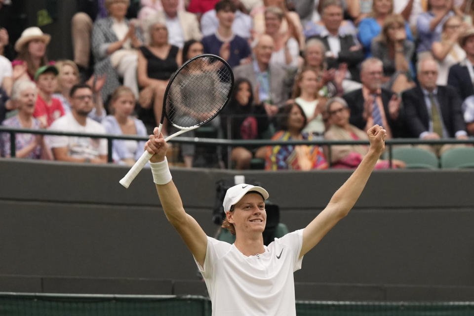 Italy's Jannik Sinner celebrates winning his match against Russia's Roman Safiullin during their men's singles match on day nine of the Wimbledon tennis championships in London, Tuesday, July 11, 2023. (AP Photo/Alberto Pezzali)