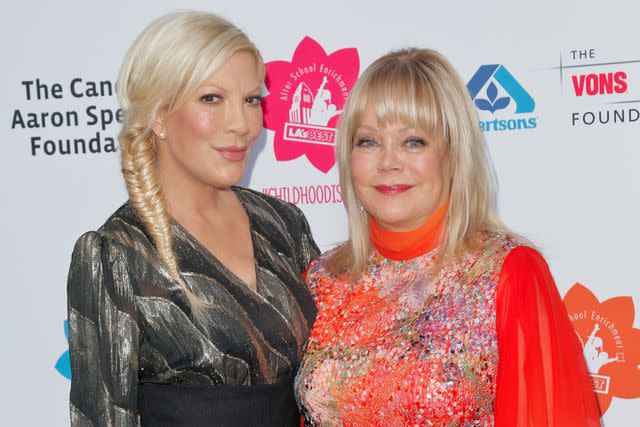 <p>Tibrina Hobson/Getty</p> Tori Spelling (left) posing with mom Candy Spelling (right) at LA's Best annual family dinner in 2015.