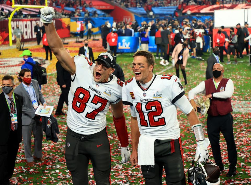 Rob Gronkowski #87 and Tom Brady #12 of the Tampa Bay Buccaneers celebrate after defeating the Kansas City Chiefs in Super Bowl LV at Raymond James Stadium on February 07, 2021 in Tampa, Florida.