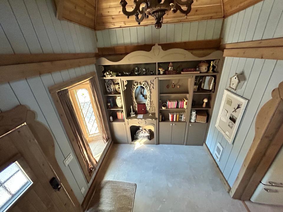 belle's cottage light blue panels and hidden bookshelf door