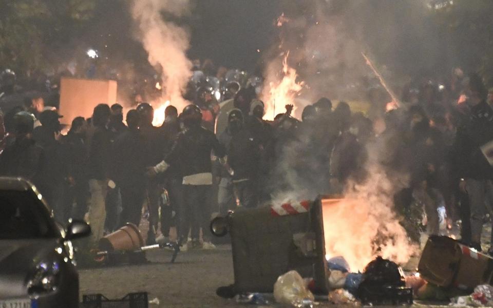 Hundreds of people clash against police during the protest over the curfew and the prospect of lockdown in Naples - STRINGER/EPA-EFE/Shutterstock