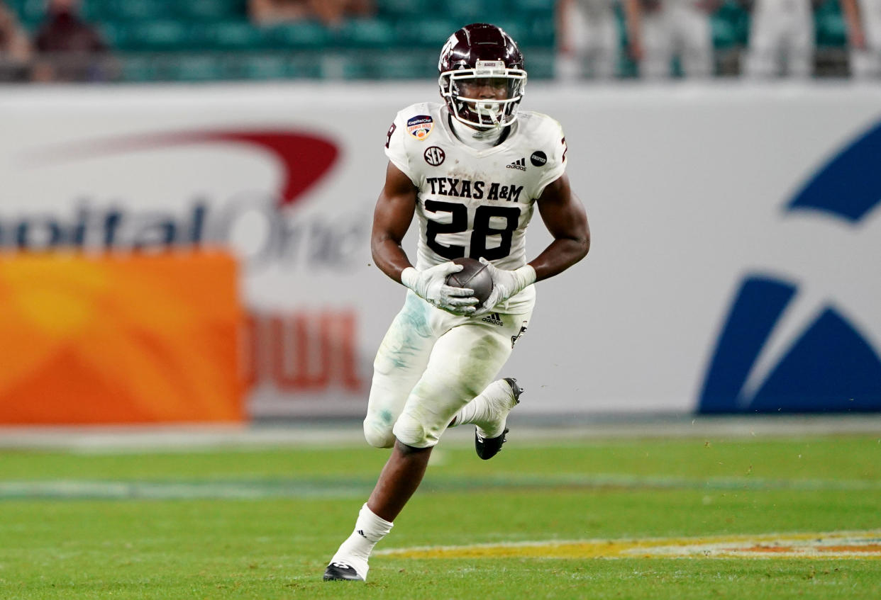 MIAMI GARDENS, FLORIDA - JANUARY 02: Isaiah Spiller #28 of the Texas A&M Aggies runs with the ball against the North Carolina Tar Heels during the first half of the Capital One Orange Bowl at Hard Rock Stadium on January 02, 2021 in Miami Gardens, Florida. (Photo by Mark Brown/Getty Images)