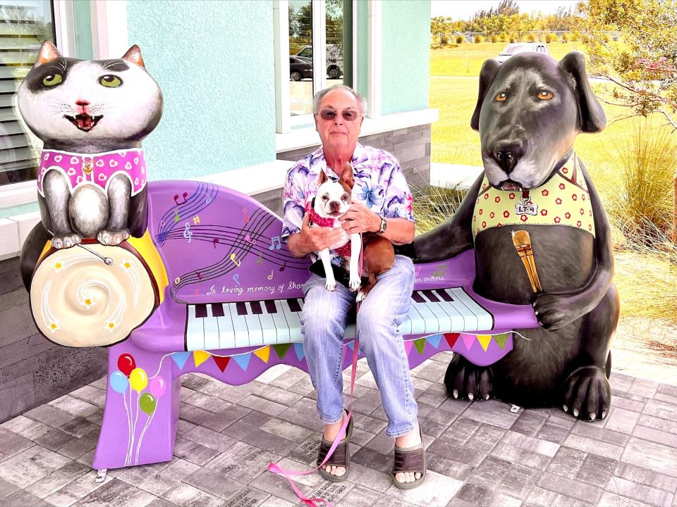Fort Myers Beach philanthropist Chuck Bodenhafer poses with his dog Maple on the bench he commissioned for Cape Coral Animal Shelter. The bench was made by Fort Myers artist Vicky Firestone.