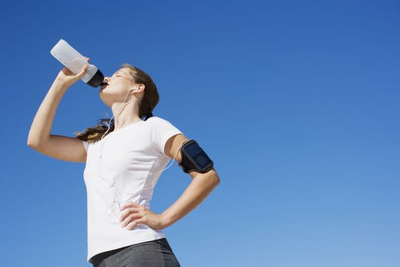 A jogger stops for a drink of water.