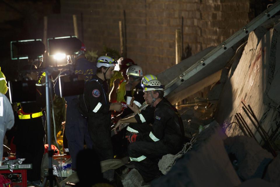 Emergency workers are seen during their search for survivors after building collapsed in Tongaat, north of Durban