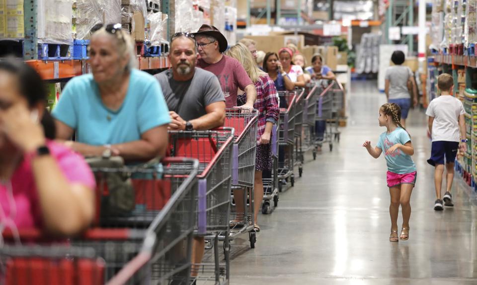 FILE - In this Aug. 30, 2019, file photo shoppers wait in line to get two cases of bottled water at the Costco store in Altamonte Springs, Fla. On Friday, Sept. 13, the Commerce Department releases U.S. retail sales data for August. (Joe Burbank/Orlando Sentinel via AP, File)