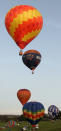 WOOTTON, UNITED KINGDOM - APRIL 07: Hot air balloons depart from Lydden Hill race circuit near Canterbury to take part in a mass crossing of the Channel on April 7, 2011 in Wootton, England. 51 balloonists of various nationalities from across Europe took off from Kent making for Calais, France at about 7am. It is the first time a Guinness World Record bid has been made for "the largest group of hot air balloons to make the Channel crossing". (Photo by Oli Scarff/Getty Images)