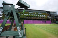 Olympic hoarding is seen on Court Six of the All England Lawn Tennis Club (AELTC) as preparations are made for the London 2012 Olympic Games, in London July 9, 2012. REUTERS/Ki Price (BRITAIN - Tags: SPORT OLYMPICS TENNIS)