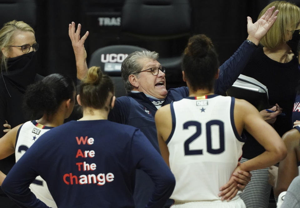 Connecticut head coach Geno Auriemma, center, talks to his team during a break in the second half against the Marquette during an NCAA college basketball game Monday, March 1, 2021, in Storrs, Conn. (David Butler II/Pool Photo via AP)