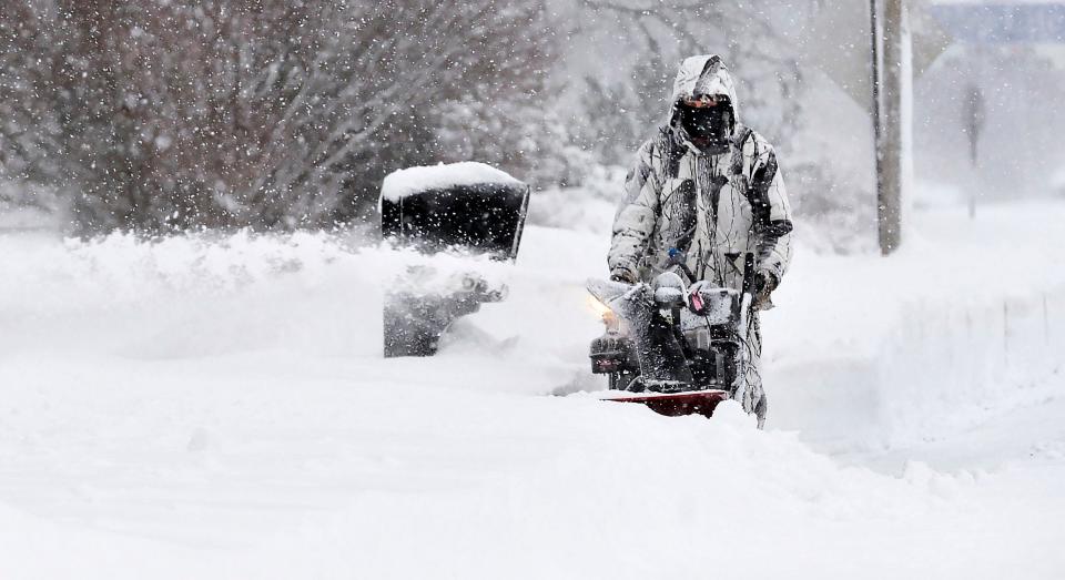 Fairview Township resident Marc Stevick clears snow on Monday, his 54th birthday, near Route 5 and Lord Road. A heavy overnight snow greeted motorists at daybreak, although schools and some businesses were closed due to the Martin Luther King Jr. holiday, reducing traffic.