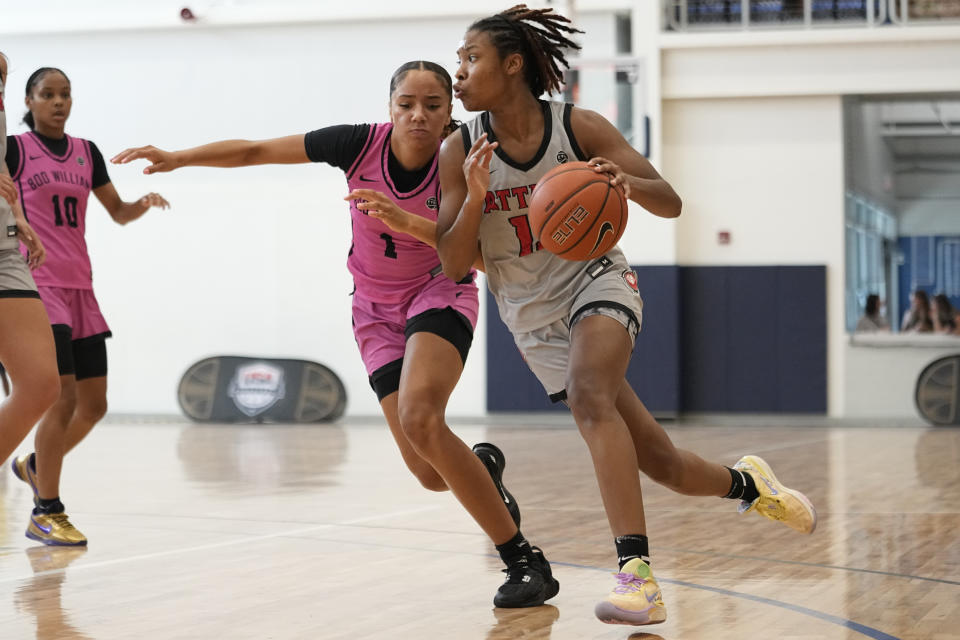 Iowa Attack guard Divine Bourrage, right, drives past Boo Williams guard Leyla Minor (1) during their game at the NCAA College Basketball Academy, Friday, July 28, 2023, in Memphis, Tenn. (AP Photo/George Walker IV)