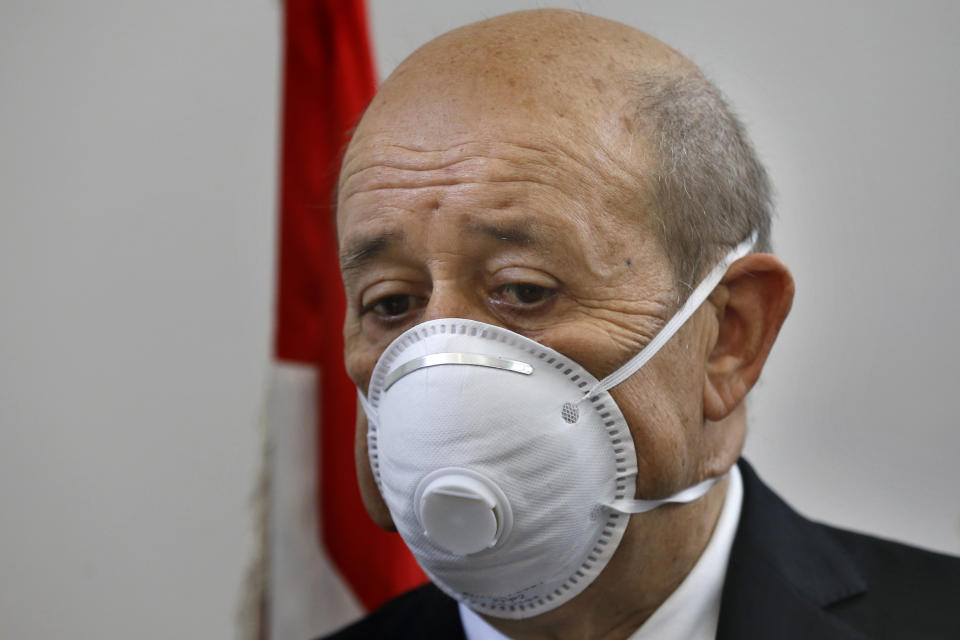 French Foreign Minister Jean-Yves Le Drian wears a mask to help prevent the spread of the coronavirus during his visit to the Carmel Saint Joseph school in the Mechref district, south of the capital Beirut, Lebanon, Friday, July 24, 2020. Le Drian pledged on Friday € 15 million ($ 17 million) in aid to Lebanon's schools, struggling under the weight of the country's major economic crisis. (AP Photo/Bilal Hussein)