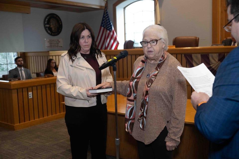 Lynn O'Toole takes the oath of office as a Toms River Township Councilwoman from lawyer Peter Pascarella as her friend, Laurie Picurro, holds the Bible on Jan. 1, 2024.