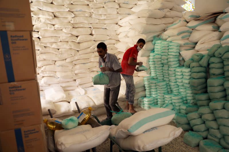FILE PHOTO: Workers prepare foodstuff for beneficiaries at a food distribution center supported by the World Food Program in Sanaa