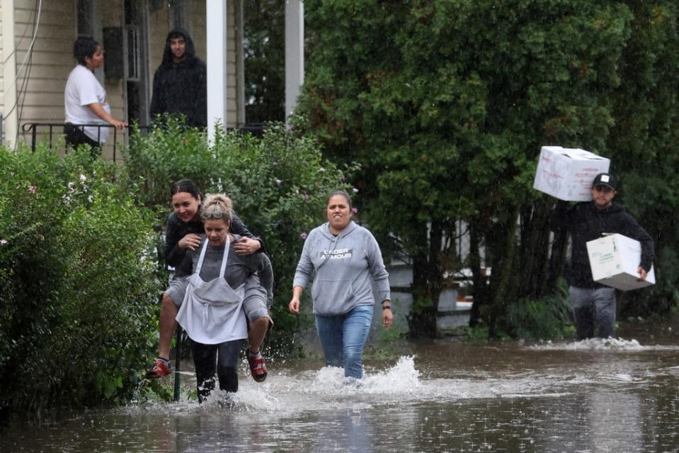 Westchester residents trudge through floodwaters during a heavy rain storm earlier this year. REUTERS