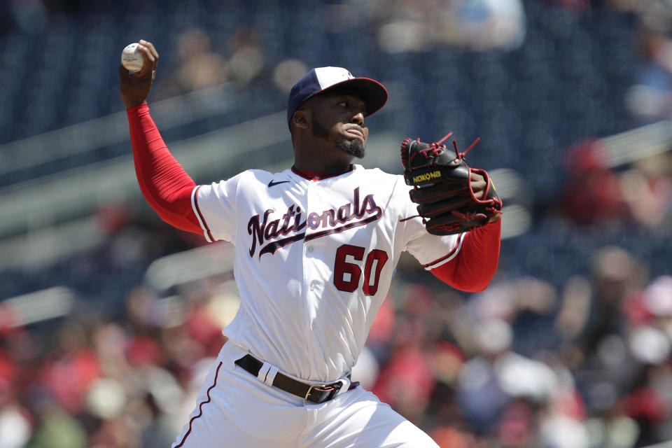 Washington Nationals starting pitcher Joan Adon delivers the ball to the San Francisco Giants during the first inning of a baseball game, Sunday, April 24, 2022, in Washington. (AP Photo/Luis M. Alvarez)