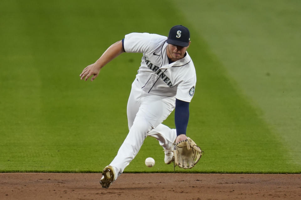 Seattle Mariners second baseman Ty France eyes a ground ball from Houston Astros' Martin Maldonado during the second inning of a baseball game Tuesday, Sept. 22, 2020, in Seattle. Maldonado was out on the play. (AP Photo/Elaine Thompson)