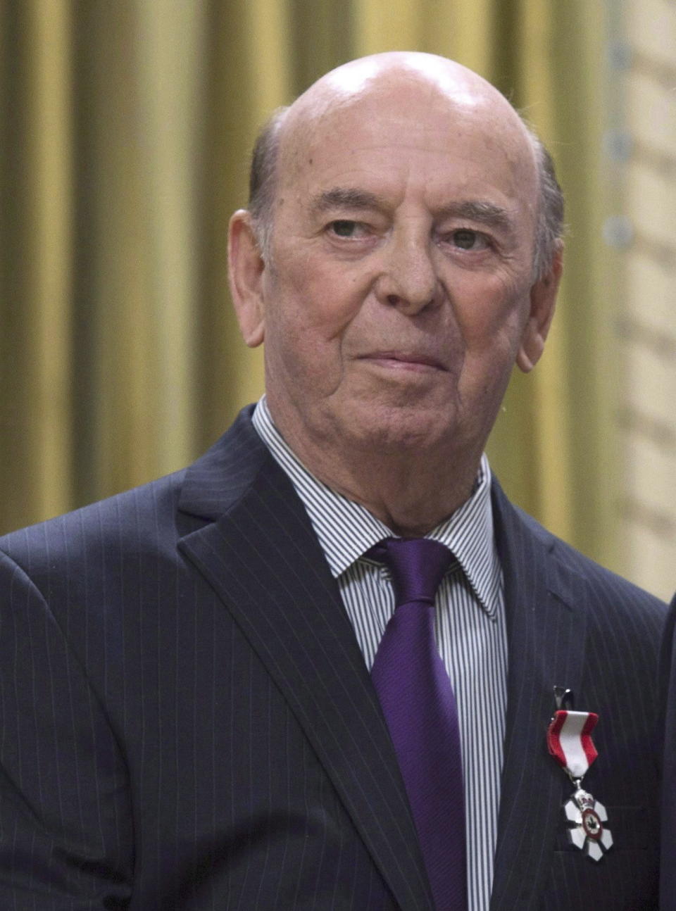 FILE - Bob Cole attends an Order of Canada ceremony at Rideau Hall, Friday, Sept. 23, 2016 in Ottawa, Ontario. Broadcaster Cole, the voice of hockey in Canada for a half-century, has died. He was 90. (Adrian Wyld/The Canadian Press via AP, FIle)