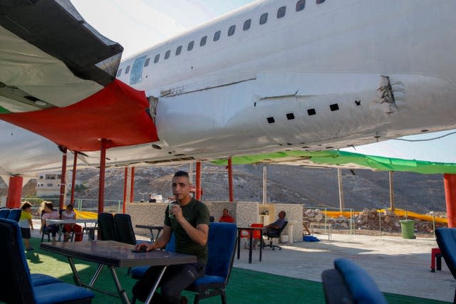 Palestinians visit a Boeing 707 aircraft after it was converted to a cafe restaurant, in Wadi Al-Badhan, near the West Bank city of Nablus