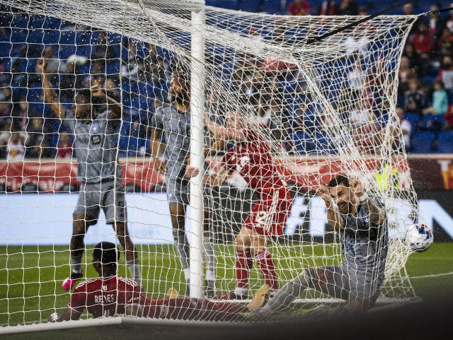 CF Montreal midfielder Mathieu Choiniere, right, scores a goal against New York Red Bulls defender Andres Reyes, front left, during an MLS soccer match Saturday, May 20, 2023, in Harrison, N.J. (AP Photo/Eduardo Munoz Alvarez)