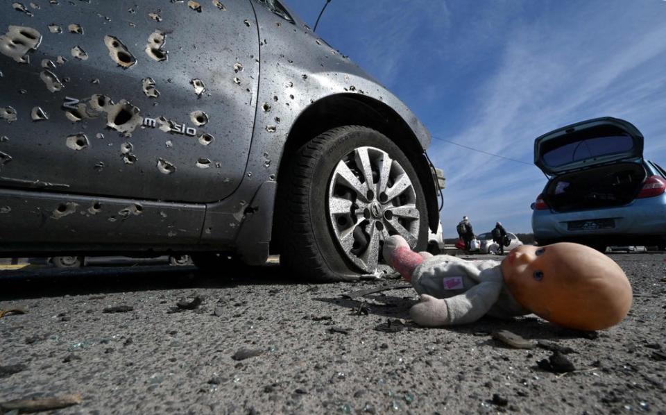 An abandoned doll next to a car riddled with bullets in Irpin, north of Kyiv. There are fears in Moldova that the war could spread from its neighbour (AFP via Getty Images)