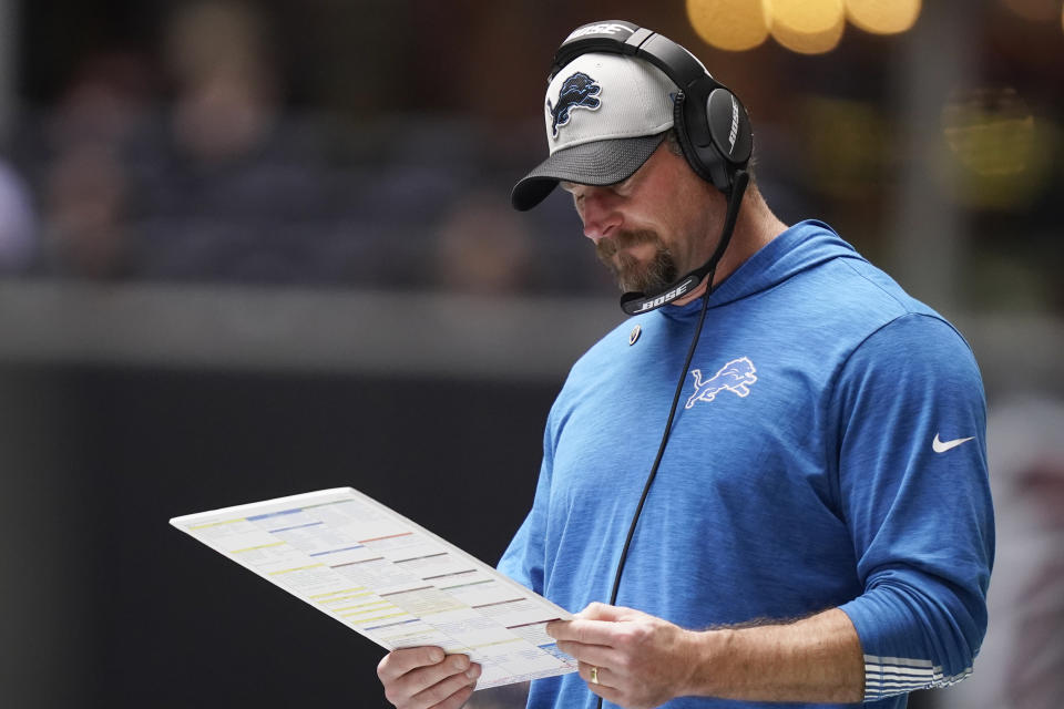 Detroit Lions head coach Dan Campbell looks at plays during the first half of an NFL football game against the Atlanta Falcons, Sunday, Dec. 26, 2021, in Atlanta. (AP Photo/Brynn Anderson)