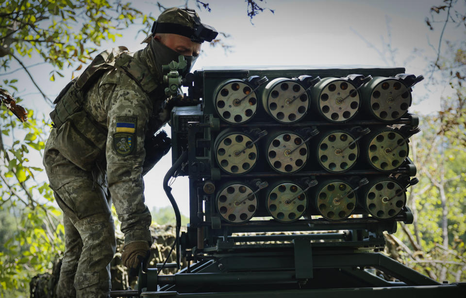 A Ukrainian soldier prepares a Croatian RAK-SA-12 128mm multiple rocket launcher to fire towards the Russian positions on the frontline near Bakhmut in the Donetsk region, Ukraine, Monday, July 10, 2023. (Roman Chop via AP)