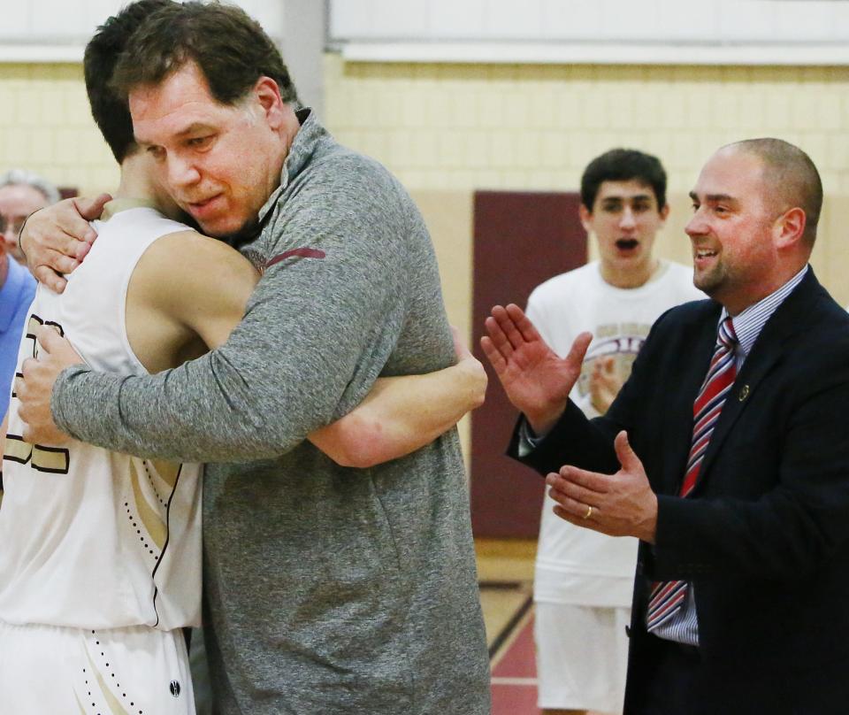 After scoring his 1001 career point, Jake Jason, left, of Old Colony is hugged by his dad, Jim Jason. To the right is Jake's happy head coach, Matt Trahan.
