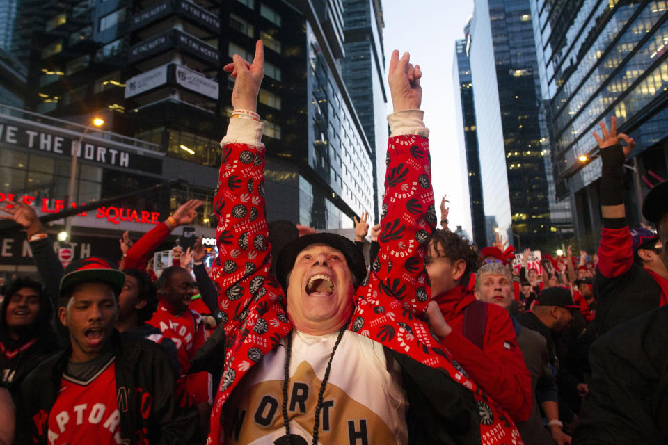 Toronto Raptors fans watch Game 2 of the NBA Finals between the Raptors and the Golden State Warriors in the fan area known as Jurassic Park, outside Scotiabank Arena in Toronto on Sunday, June 2, 2019. (Chris Young/The Canadian Press via AP)