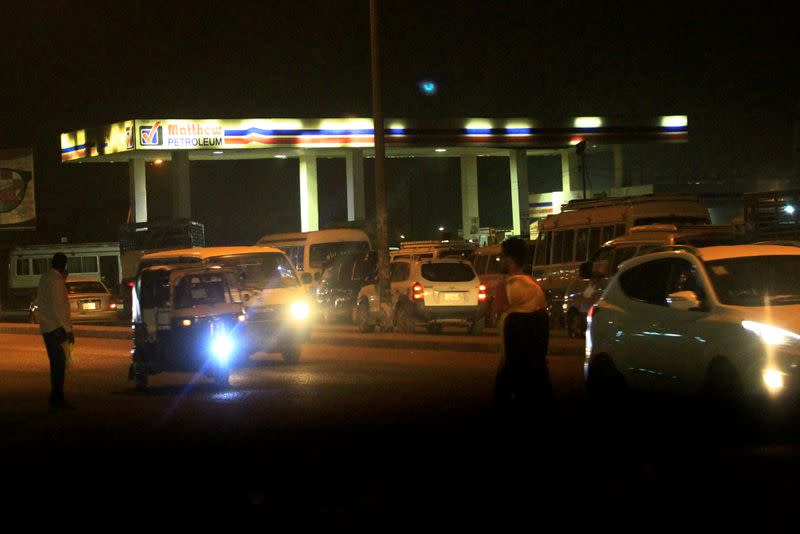 FILE PHOTO: Motorists queue to fuel up at a petrol station in Khartoum, Sudan