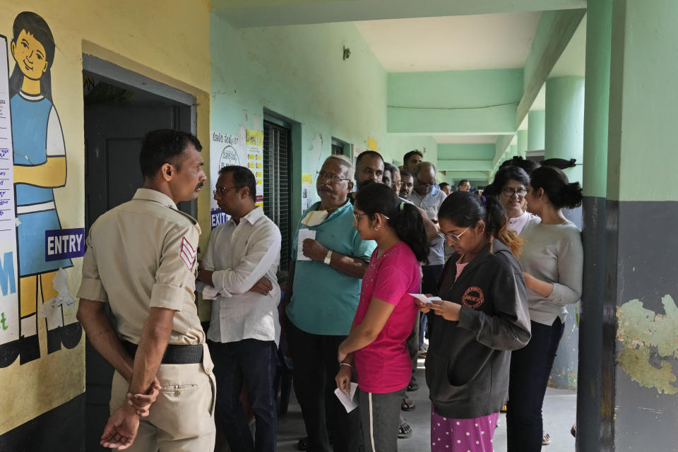 People line up to caste their votes at a polling station in Bengaluru, India, Wednesday, May 10, 2023. Thousands of people began voting Wednesday in a key southern Indian state where pre-poll projections have put the opposition Congress ahead of Prime Minister Narendra Modi's governing Hindu nationalist party. (AP Photo/Aijaz Rahi)