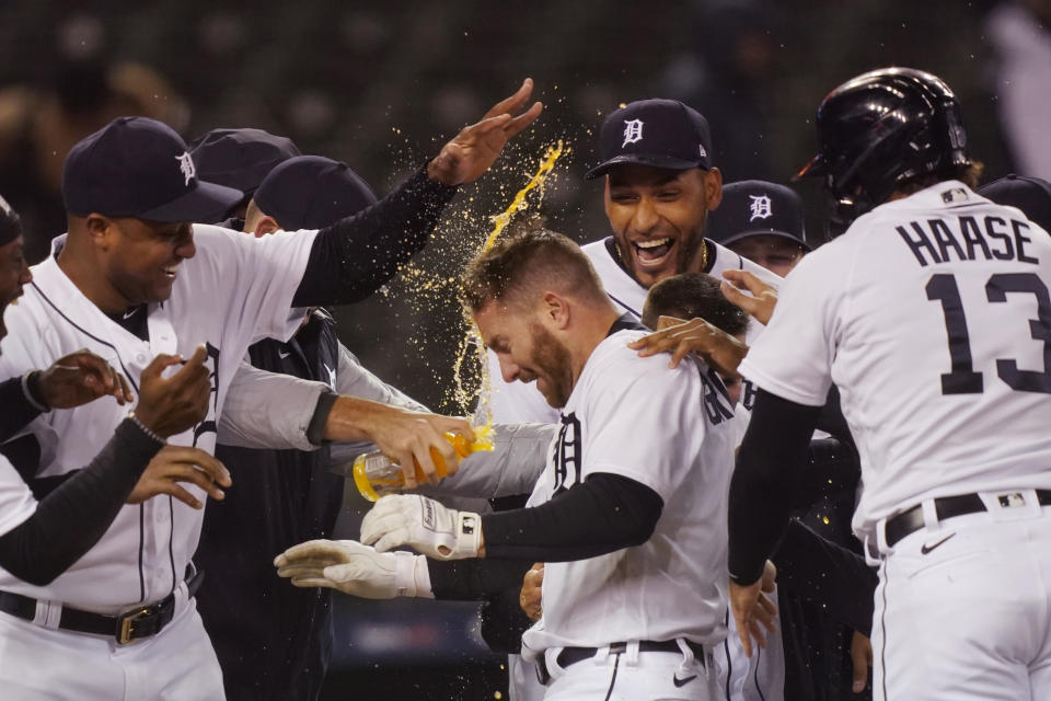 Detroit Tigers' Robbie Grossman is greeted by teammates after a two-run walk-off home run during the 10th inning of a baseball game against the New York Yankees, Friday, May 28, 2021, in Detroit. (AP Photo/Carlos Osorio)