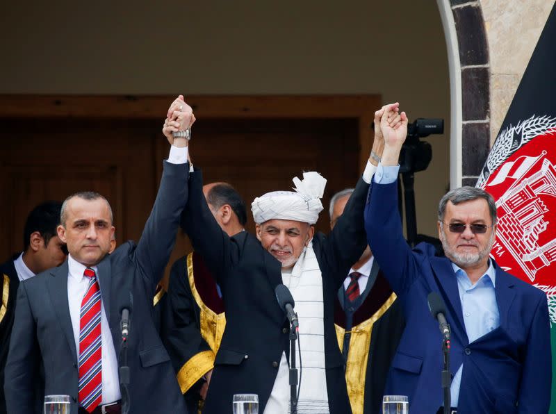 Afghanistan's President Ashraf Ghani (C), first Vice President Amrullah Saleh (L) and second Vice President Sarwar Danish (R) gesture during their swearing-in ceremony, in Kabul