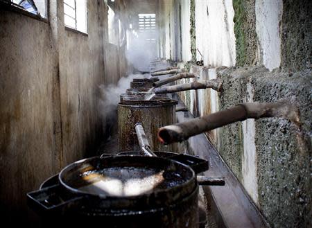 Vetiver oil flows from the stills into vats at the Agri-supply distillery, the largest Vetiver distillery in the world, in Les Cayes, on Haiti's southwest coast, March 27, 2014. REUTERS/stringer