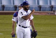 Los Angeles Dodgers relief pitcher Kenley Jansen, right, gestures as catcher Austin Barnes looks on after the Dodgers defeated the Colorado Rockies 4-2 in a baseball game Wednesday, April 14, 2021, in Los Angeles. (AP Photo/Mark J. Terrill)