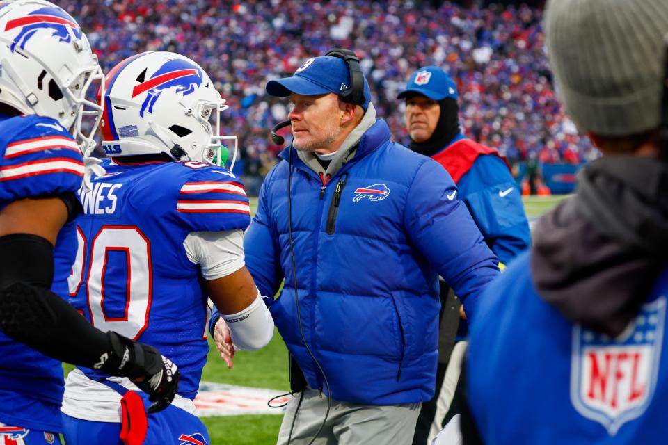 Bills head coach Sean McDermott celebrates with Nyheim Hines (20) after the latter's 101-yard touchdown on a third-quarter kickoff return against the Patriots, Sunday, Jan. 8, 2023, in Orchard Park.
