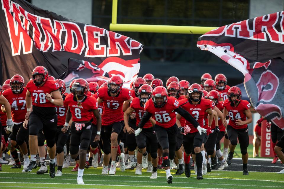 Winder-Barrow takes the field during a GHSA high school football game between Winder-Barrow and Apalachee in Winder, Ga., on Friday, Aug. 20, 2021. Winder-Barrow won the game 19-3. (Photo/ Jenn Finch, The Athens Banner-Herald)