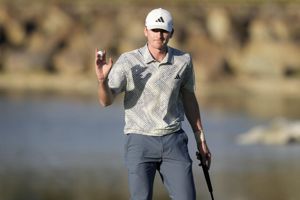 Nick Dunlap reacts to the crowd after making his putt on the 17th hole of the Pete Dye Stadium Course during the final round of the American Express golf tournament, Sunday, Jan. 21, 2024, in La Quinta, Calif. (AP Photo/Ryan Sun)